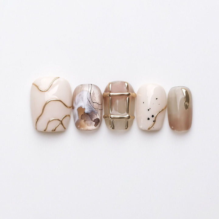 Dawn 3D press-on nails in neutral shades with gold details
